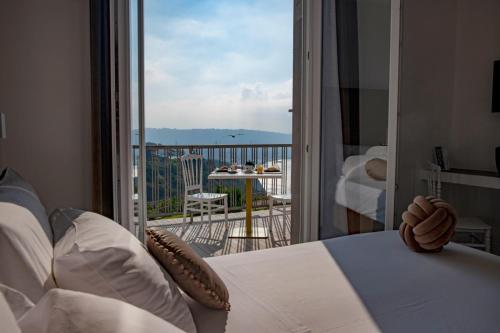 a bedroom with a bed and a view of a balcony at GRAND HOTEL SERAPIDE in Pozzuoli