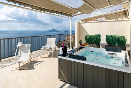 a hot tub on the balcony of a house at GRAND HOTEL SERAPIDE in Pozzuoli