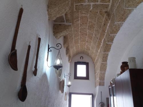 a room with some utensils hanging on the wall at Casa Cassiano in Patù