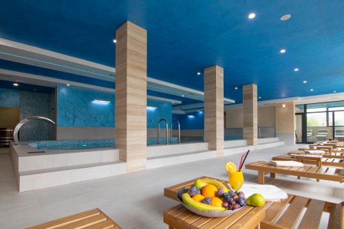a restaurant with a bowl of fruit on a table at Hotel Agape in Zlatibor