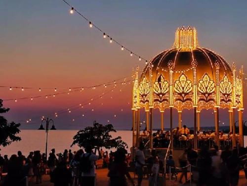 a group of people standing around a gazebo with lights at Casa Cassiano in Patù
