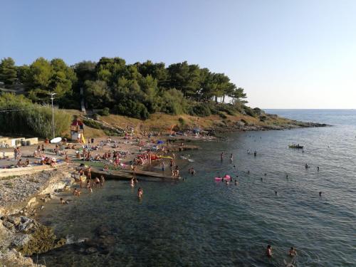 a group of people in the water at a beach at Casa Cassiano in Patù