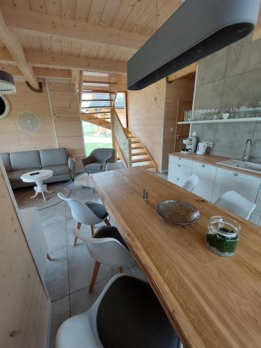 a kitchen and dining room with a wooden table and chairs at WIOSKA RUSIŃSKI in Bukowina Tatrzańska