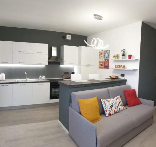 a kitchen with a couch with colorful pillows on it at OLTRE LE NUVOLE in Cuneo