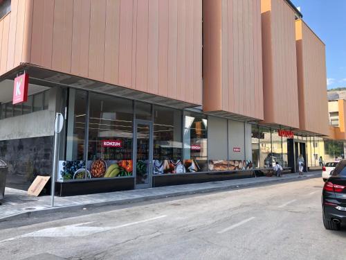 a store front with fruits and vegetables in the windows at Hard Rock Rooms for two in Livno
