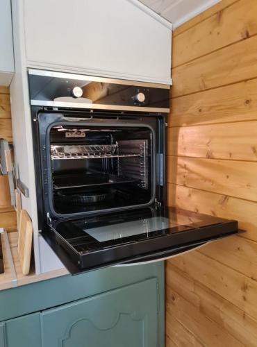 a microwave oven sitting on top of a kitchen counter at Chalet Olivier in Fléré-la-Rivière