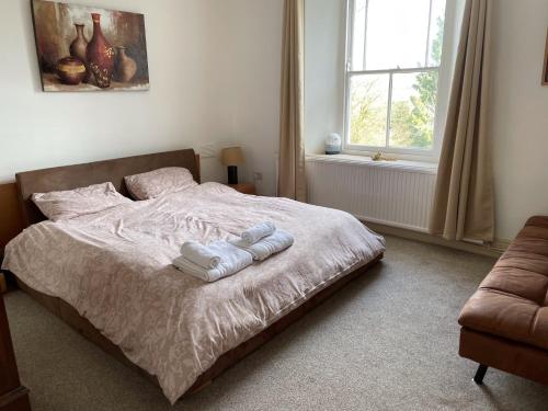 a bedroom with a bed with two towels on it at Hilltop in Llandeilo