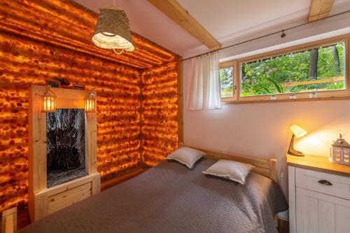 a bedroom with a bed next to a window at Osada Sudecka in Lądek-Zdrój