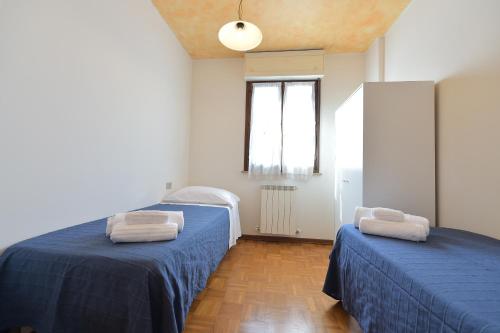 Ένα ή περισσότερα κρεβάτια σε δωμάτιο στο CASA VACANZE RELAX duepassi dal riviera horses