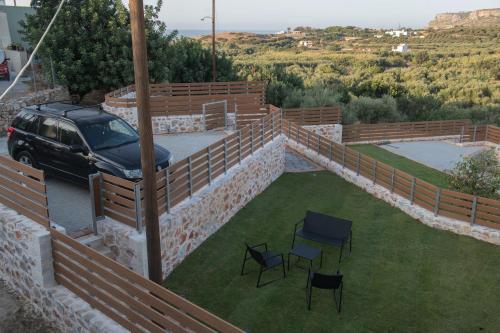 a car parked on a retaining wall with a lawn at Petrino in Sisi with private pool and garden in Sissi