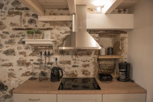 a kitchen with a sink and a stove top at Petrino in Sisi with private pool and garden in Sissi