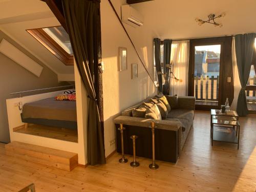 a living room with a couch and a bed at Apartment Skyline of Jena, luxuriös, einzigartig, free Wifi, Parkplatz, klimatisiert, zentral in Jena