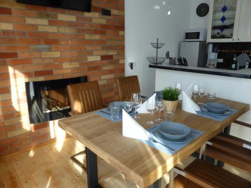 a dining room with a wooden table and a fireplace at Apartment Skyline of Jena, luxuriös, einzigartig, free Wifi, Parkplatz, klimatisiert, zentral in Jena
