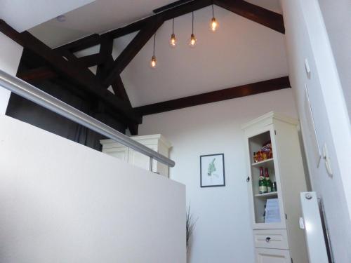 a kitchen with wooden beams and a white refrigerator at Apartment Skyline of Jena, luxuriös, einzigartig, free Wifi, Parkplatz, klimatisiert, zentral in Jena