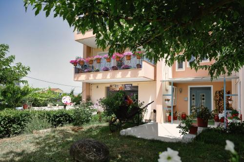 a building with a balcony with flowers on it at Amazing Place in Pedini in Ioannina