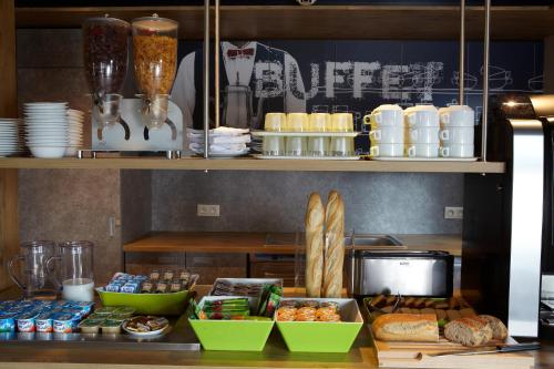 a counter with food and other food items on it at ibis budget Pontarlier in Pontarlier