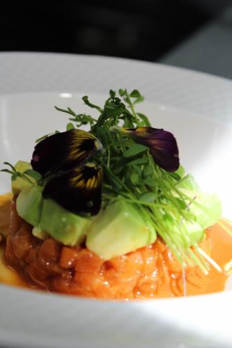 a plate of food with vegetables on top of pasta at Mansion Alcazar in Cuenca