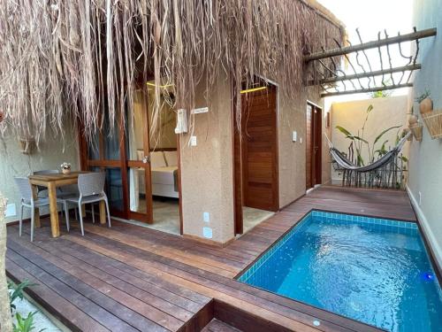 a house with a swimming pool on a wooden deck at Naim Milagres in São Miguel dos Milagres