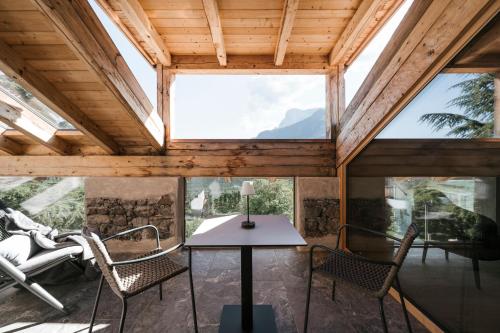 a room with a table and chairs in a house at St. Vigilius modern historic apartments in Nalles