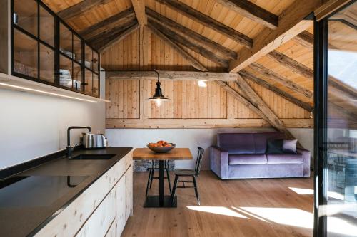 an open kitchen and dining room with a table at St. Vigilius modern historic apartments in Nalles