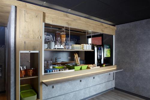 a kitchen with a counter in a room at ibis budget Pontarlier in Pontarlier