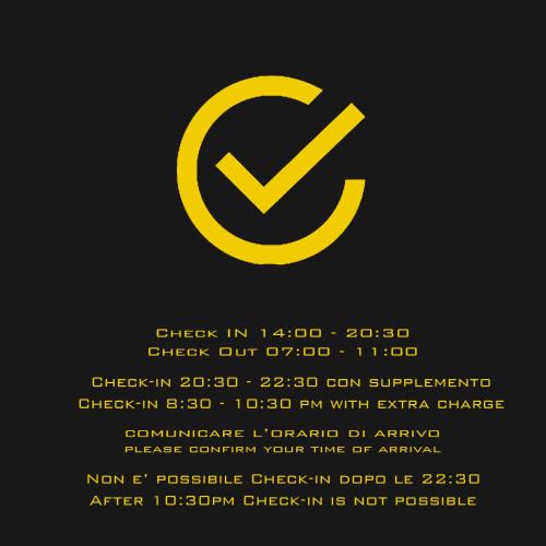 a yellow check in sign on a black background at Tufo Giallo Rooms in San Giorgio a Cremano