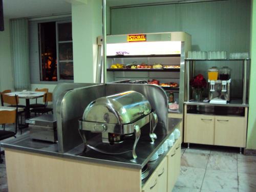 a kitchen with a mixer on top of a counter at Estoril Hotel in Belo Horizonte