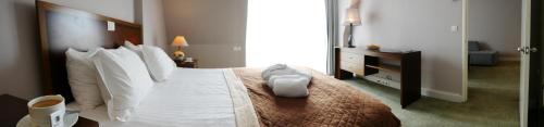 a bedroom with a large bed with white pillows at TALEN OTEL in Istanbul