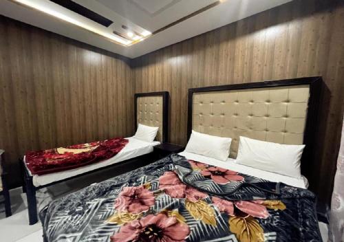 a bedroom with two beds in a room at Oriole Guest House Economy Living in Islamabad