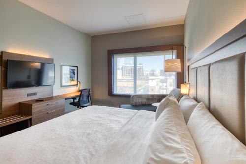 a hotel room with a bed and a television at Holiday Inn Express & Suites - Charlotte - South End by IHG in Charlotte