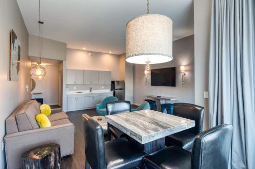 a living room with a table and chairs and a kitchen at Holiday Inn Express & Suites - Charlotte - South End by IHG in Charlotte