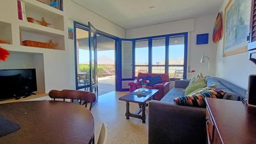 a living room with a couch and a table at alquilaencanarias El Medano Spectacular terrace and sea views A in El Médano