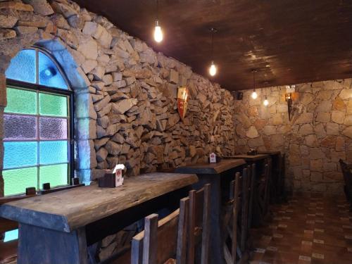 a stone wall with a row of benches in a restaurant at Hotel Vila Suíça 1818 in Nova Friburgo