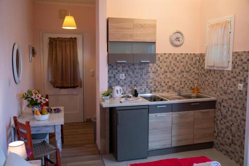 a kitchen with a sink and a counter top at Villa Voula in Agios Stefanos