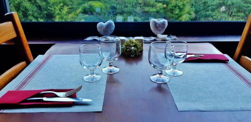 a table with wine glasses on top of a table at Auberge Cevenole in Valleraugue