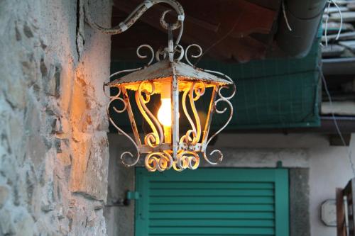 a chandelier hanging from a building with a green door at Agriturismo Saudon in Mulazzo