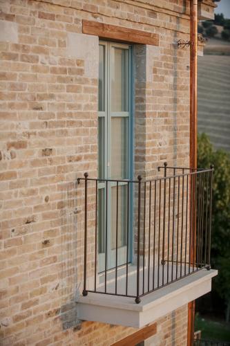 a window on a brick building with a balcony at Villa Sant'Angelo in Alba Adriatica