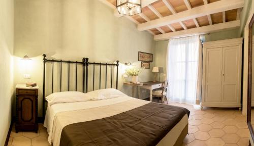 a bedroom with a bed and a table and a window at Villa Sant'Angelo in Alba Adriatica