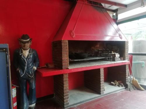 a figurine of a man standing next to a brick oven at Katana Capsule Hostel in Mendoza