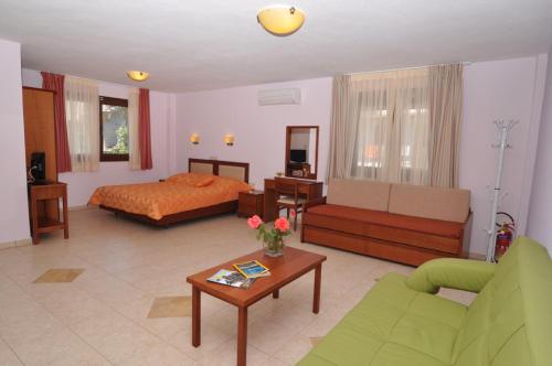 a living room with a bed and a couch at Elia Studios in Skala Marion