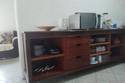 a wooden shelf with a microwave on top of it at Departamento Las Marianas in Valle de Bravo