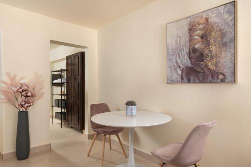 a dining room with a white table and chairs at To Rodi Apartments in Rhodes Town