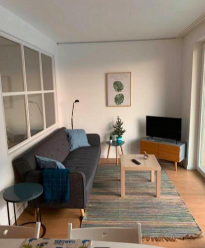 a living room with a couch and a table at Cozy canide beach apartment in Canidelo