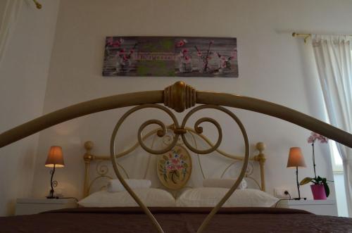 a bedroom with a bed with a wooden head board at Villa Claudia in Fažana