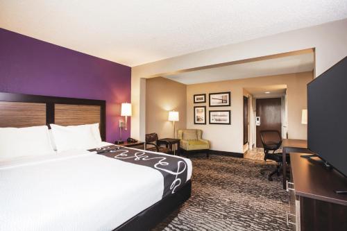 a hotel room with a bed and a desk at La Quinta by Wyndham Clearwater South in Clearwater