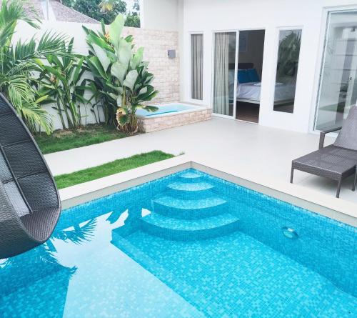 a swimming pool with blue tiles in a house at Pineale Villas, Resort and Spa in Panglao