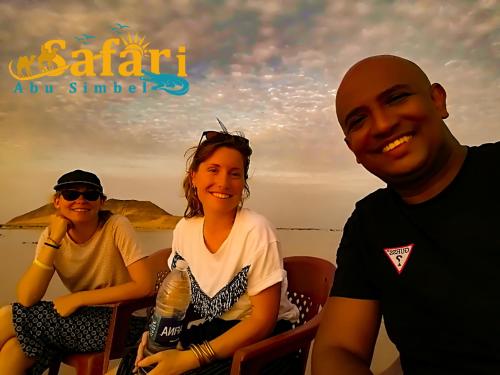 three people sitting on a boat in the water at Safari Abu Simbel in Abu Simbel