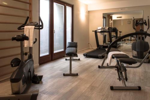 a gym with treadmills and exercise equipment in a room at Hotel Relais Agli Olivi in Lazise