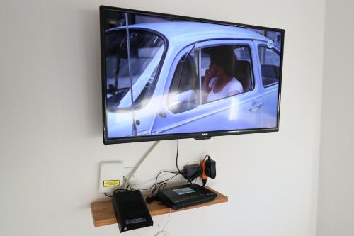 a flat screen tv hanging on a wall at Departamento Asturias in La Paz