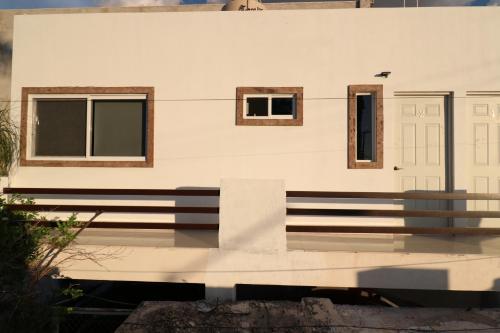 a white house with windows and a door at Departamento Asturias in La Paz